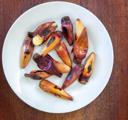 Roasted and cooked  pinion, pine nuts from the Araucária angustifolia tree (Pinheiro do Paraná), a prehistoric tree. Top view on the wooden table