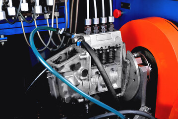A fuel pump for a diesel engine after repair on an adjustment stand in a workshop, fuel pump...
