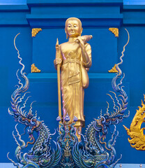 Buddha statue in Thai Lanna style - exterior detail of Famous Wat Rong Suea Ten, or Blue Temple in Chiangrai, Chiang Rai Province, Northern Thailand