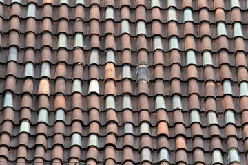 Tile roof texture. Tiled acute-angled cross-slab. Roof tiles made from fired clay
