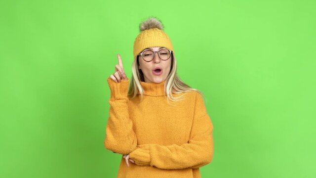 Young woman with glasses standing and thinking over isolated background on green screen chroma key