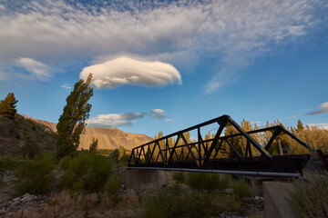 Scene view of an iron railway bridge against mountains during sunset in Esquel, Patagonia, Argentina