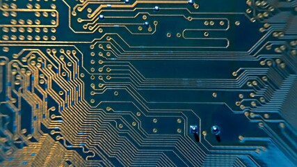 Golden colors metallic conductors on a printed circuit board along which a beam of light moves. Macro. Closeup - Powered by Adobe