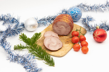 Smoked Turkey roll with herbs on a Christmas wooden background.