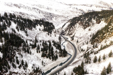 Aerial view of the Richardson Highway, Keystone Canyon, and Lowe River near Valdez, Alaska during the winter.