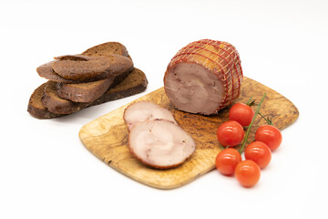 Smoked Turkey roll with herbs on a wooden background.