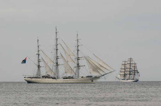SWINOUJSCIE, WEST POMERANIAN / POLAND - 2017: Sailing ship RNOV SHABAB OMAN and CISNE BRANCO flows through the waterway on the sea
