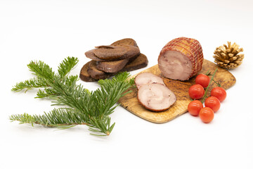 Smoked Turkey roll with herbs on a wooden background.