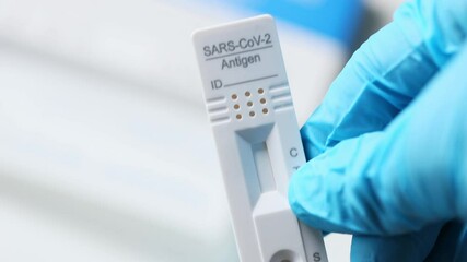 a rapid corona antigen test in one hand