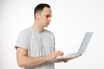 a man holds an open computer on a white background