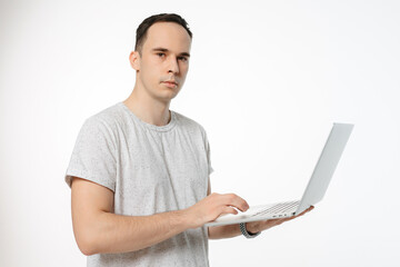 a man holds an open computer on a white background