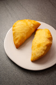 fried panzerotto on plate. panzerotto stuffed with mozzarella and tomato. Typical Apulian cuisine, Italy