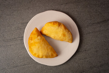 fried panzerotto on plate. panzerotto stuffed with mozzarella and tomato. Typical Apulian cuisine, Italy