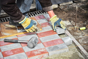 Worker lays down paving slabs. Work process.