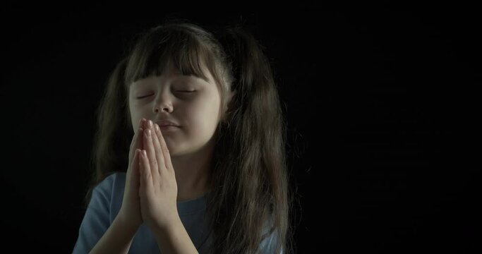 A beautiful child in prayer.