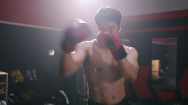 Athlete man Boxing workout training exercise in Fitness Gym Healthy Lifestyle bodybuilding, Athlete doing punching builder muscles lifestyle, Happy health care mobility concept.