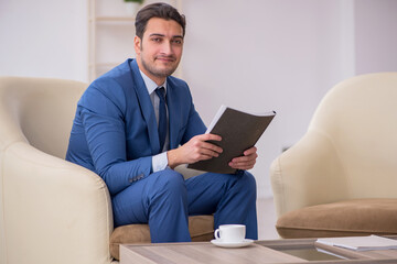 Young male employee waiting for business meeting