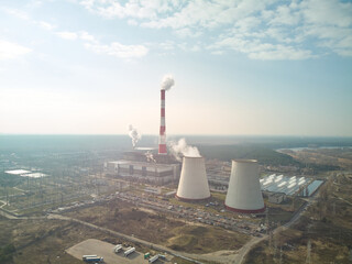 big nuclear plant on side of a city.