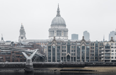 Fototapeta na wymiar City of London and St. Pauls cathedral in raining, misty day view from the River Thames. Empty streets of London during national lockdown UK, 2021