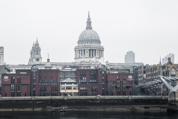 Naklejka premium City of London and St. Pauls cathedral in raining, misty day view from the River Thames. Empty streets of London during national lockdown UK, 2021