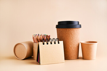 branding mockup with many craft paper and different subjects, glass for coffee. Office desk with a paper notepad and a box of pencils. Contemporary workspace for men, minimalist style. Mockup. 