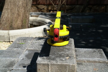 Laser spirit level for laying flagstone in the garden. 
