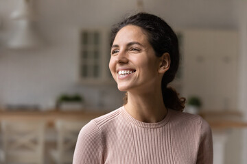 I am doing fine. Smiling motivated young latin lady look at distance with belief in good hope...