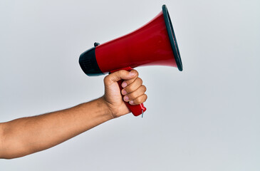 Hand of hispanic man holding megaphone over isolated white background.