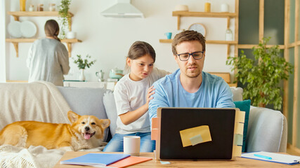 Social Distancing. A Busy Father Tries to Work Remotely with His Child and Wife at Home. The...