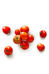 Top view of a pile of organic red tomatoes from the garden isolated on a white background
