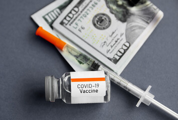 syringe and vaccine ampoule, American dollar money banknotes,  coronavirus pandemic, vaccine availability in rich and poor countries. sale of medicines.