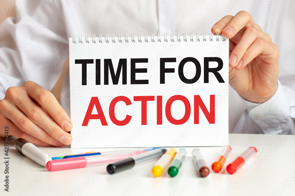 Poster a sheet of paper with text time for action, multicolored markers on a white table. business and educ