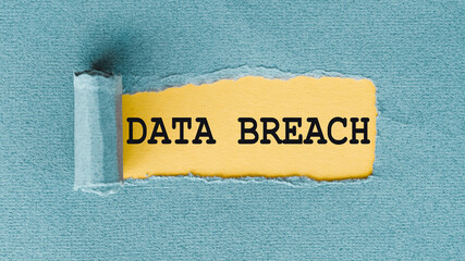 DATA BREACH words written under ripped and torn paper.