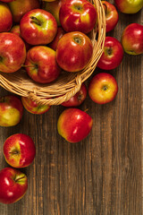 Fresh red apples in basket on the wooden table.Top view with copy space.Rustic food background.