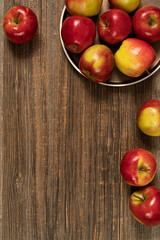 Fresh red apples in plate on the wooden table.Top view with copy space.