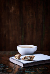Cantuccini (Italian cookie) and Cappuccino on dark wooden background. Copy space.