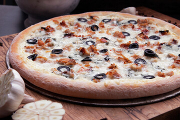 Delicious homemade pizza on a wooden background