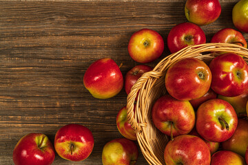 Fresh red apples in basket on the wooden table.Top view with copy space.Rustic food background.