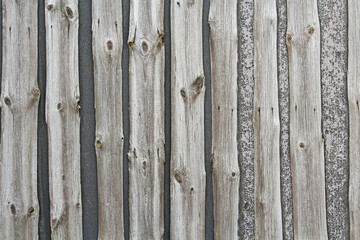 The wall of the building is made of old planks.