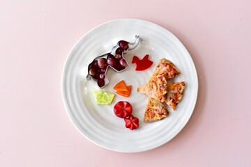 Fun kids food creatively arranged to entice healthy eating for children's meals. Photo concept, creative food, background, copy space