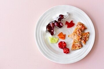 Fun kids food creatively arranged to entice healthy eating for children's meals. Photo concept, creative food, background, copy space