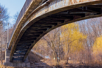 old rusted metal bridge over the river in the autumn in the city park in Kharkiv, Ukraine
