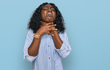 Beautiful african young woman wearing casual clothes and glasses shouting suffocate because painful strangle. health problem. asphyxiate and suicide concept.