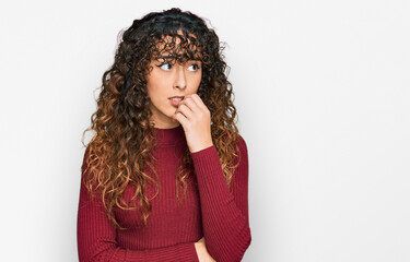 Fototapeta na wymiar Young hispanic girl wearing casual clothes looking stressed and nervous with hands on mouth biting nails. anxiety problem.