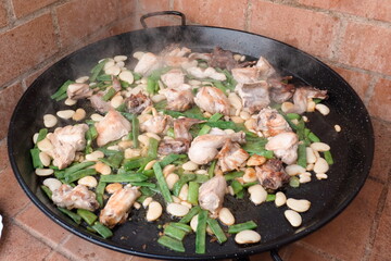Valencian paella stir-fry with chicken and rabbit