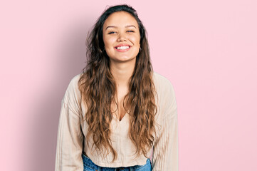 Fototapeta premium Young hispanic girl wearing casual clothes with a happy and cool smile on face. lucky person.