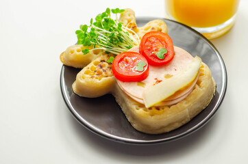 Reindeer shaped crumpets served with ham, tomato, cucumber, and watercress
