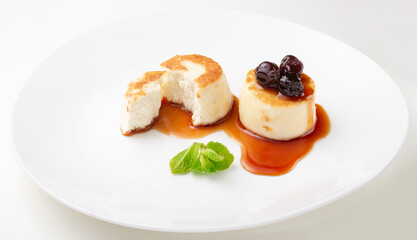 Cheesecakes on a plate with jam and berries on top