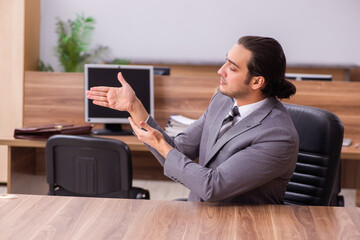 Young businessman employee sitting in the office
