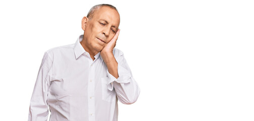 Handsome senior man wearing elegant white shirt thinking looking tired and bored with depression problems with crossed arms.